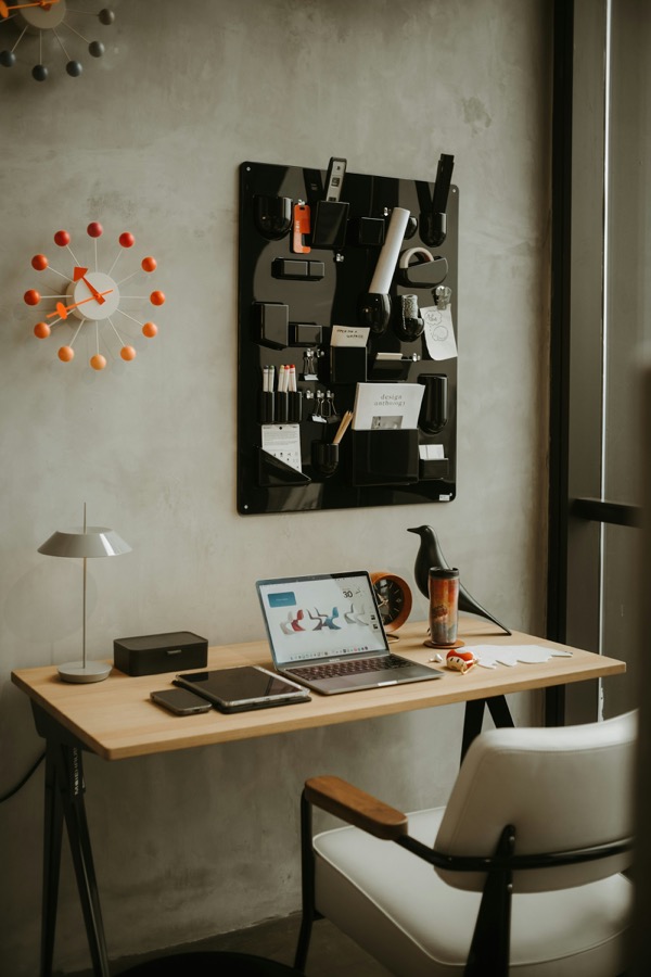 A minimal desk workspace with a laptop, representing a calm, focused approach to managing money